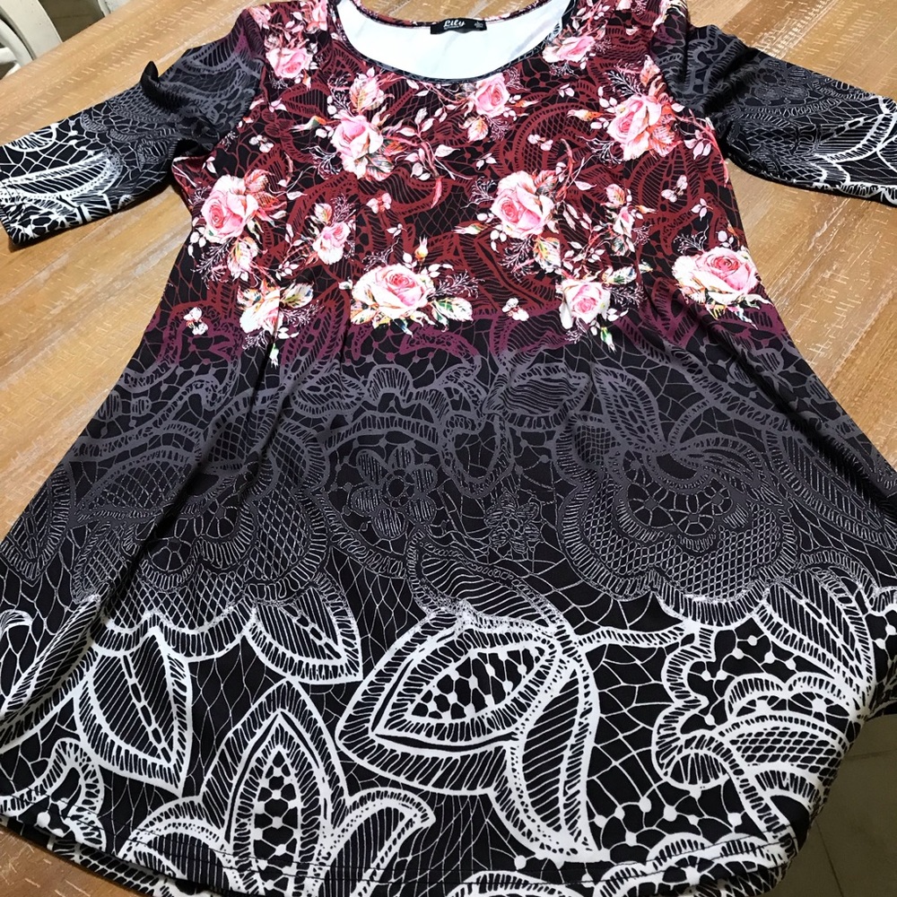 Tunic top with black background.  Never worn.